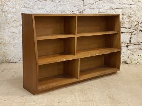 A mid century teak floor standing open waterfall bookcase, fitted with a combination of fixed