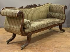 A Regency mahogany scroll arm sofa, the shaped crest rail with a pediment carved with scrolling
