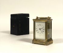 A French brass repeating carriage clock, late 19th century, the gilt brass case with swing handle an