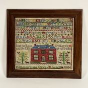 A 19th century needlework sampler, worked in coloured threads with a house, verse, bands of alphabet