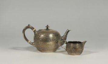 A Victorian Scottish silver bachelor's teapot and cream jug in the Indian taste, maker's mark JR, Gl
