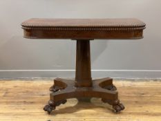 A William IV rosewood supper table, the foldover revolving top with beaded moulding to edge, above a