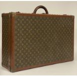 A Louis Vuitton suitcase / trunk, the LV monogrammed canvas exterior with leather handle