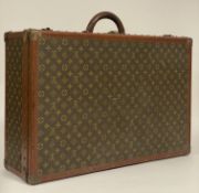 A Louis Vuitton suitcase / trunk, the LV monogrammed canvas exterior with leather handle