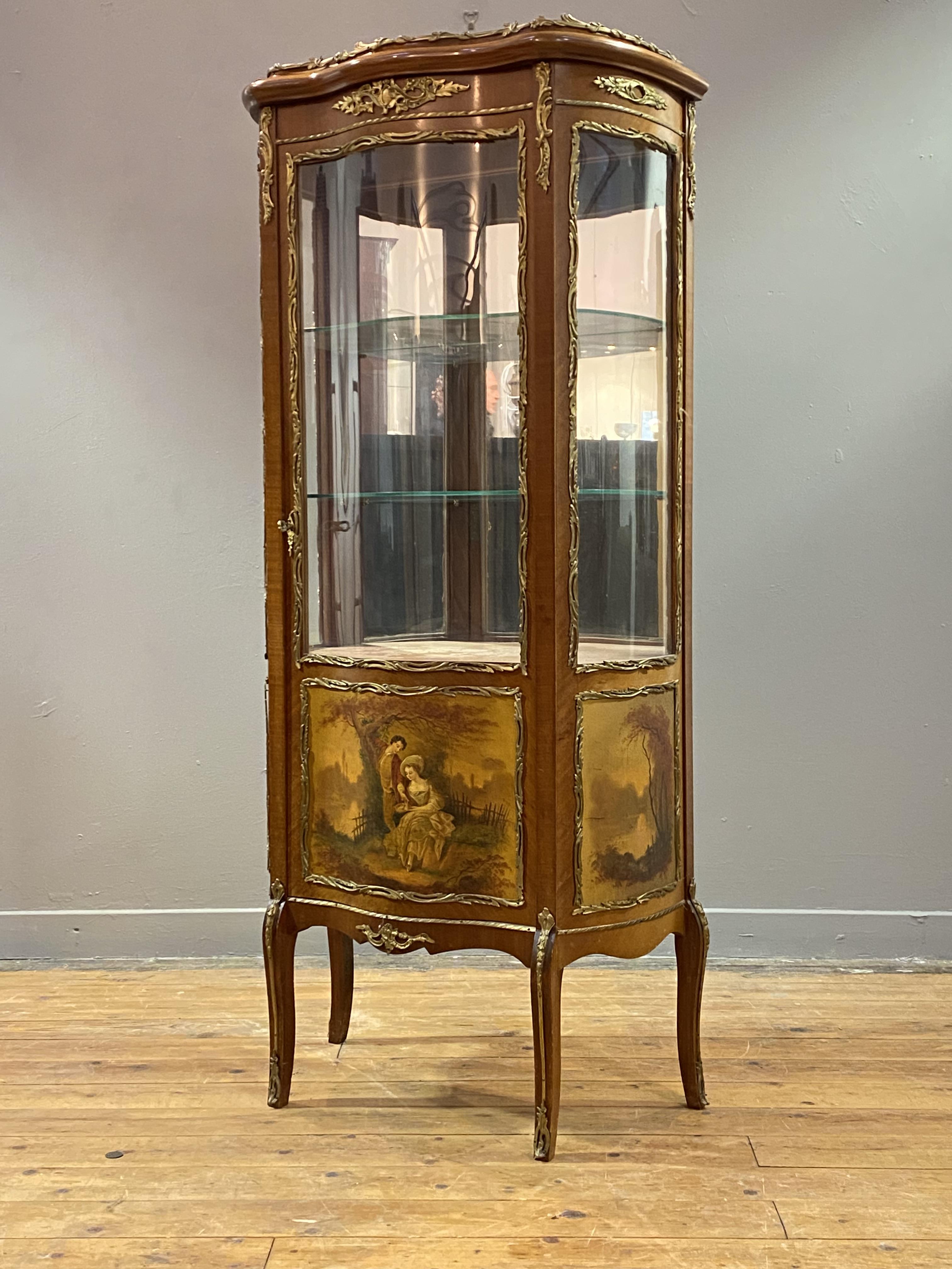 A mahogany vitrine display cabinet of serpentine outline in the French taste, early 20th century,