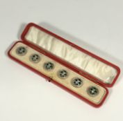 A cased set of six white metal and green enamel buttons, early 20th century