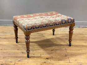 A Victorian walnut duet stool, the seat upholstered in period embroidered fabric worked in a