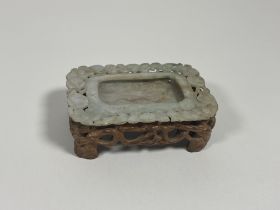 A Chinese jadeite shallow dish, of mottled brown celadon colour and of shaped rectangular form