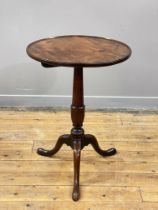 A George III mahogany wine table, the dished circular top over a turned column of urn form, raised