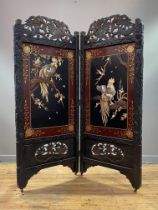 A Japanese ebonised hardwood folding room screen, early 20th century, the pediment pierce-carved