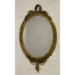 Charles Nosotti, A 19th century giltwood and gesso wall hanging mirror of oval outline, the frame