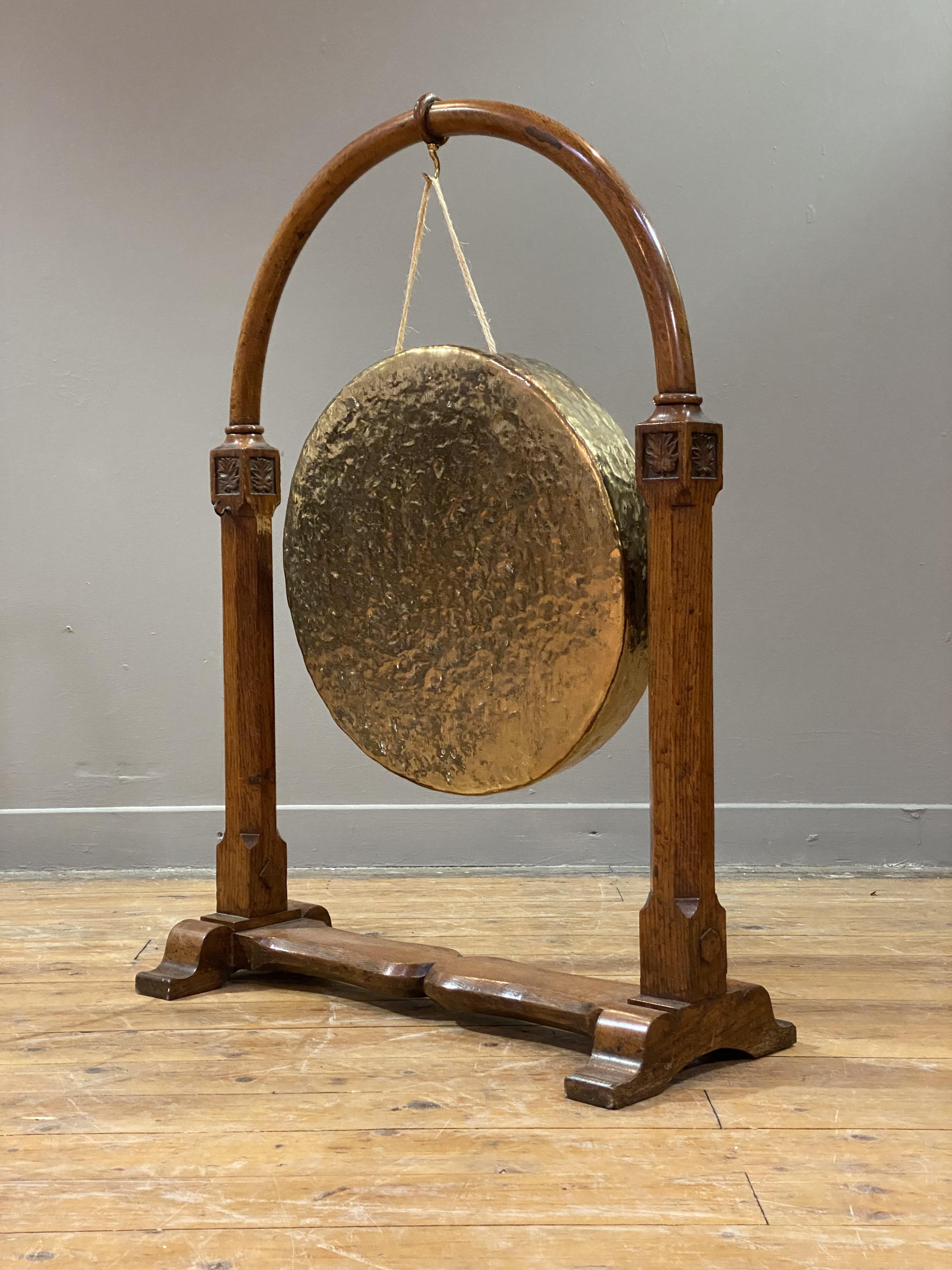 A Victorian floor standing dinner gong, the hammered brass gong hanging from an oak frame with