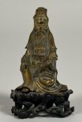 A small Chinese bronze figure of Guanyin, modelled seated in rajalilasana