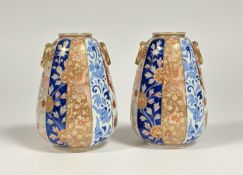 A pair of Japanese Imari porcelain vases, Meiji period, c. 1900, of tapering cylindrical form with m