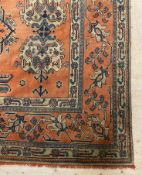 A Turkey Ushak carpet, late 19th century, the red ground of stylised floral design enclosed by