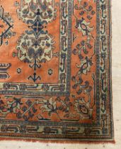 A Turkey Ushak carpet, late 19th century, the red ground of stylised floral design enclosed by