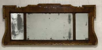 A late 18th century walnut overmantel mirror, with parcel-gilt floral moulded border enclosing