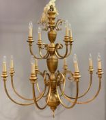 Bella Figura, a large and impressive pair of Italian gilt metal chandeliers each with central column