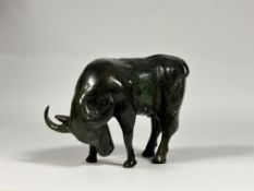A Chinese patinated metal model of a standing ox