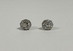 A pair of diamond cluster earrings, c. 1900, of oval flowerhead form
