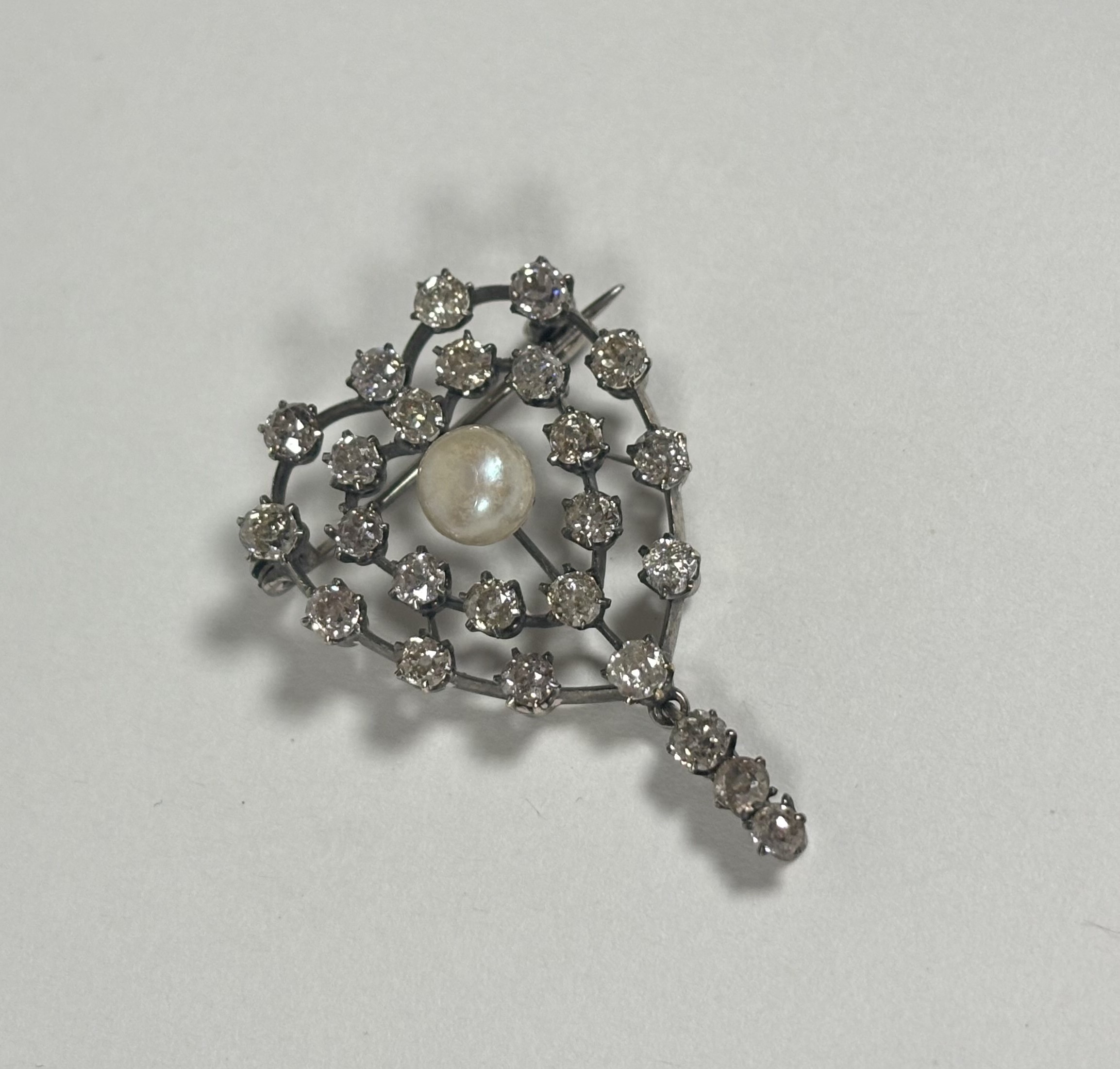 A late 19th century old-cut diamond and pearl brooch of heart form