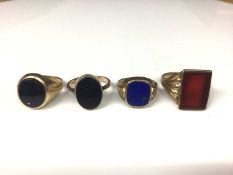 Four 9ct gold semi precious polished stone panel signet rings to include two oval onyx, sizes S½ and