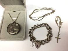 Heavy silver curb link bracelet with padlock clasp, silver locket on chain, cross pendant on chain a