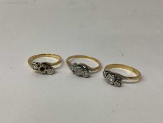 Three 18ct gold diamond three stone rings, each with three small diamonds in platinum illusion setti