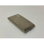 George V silver cigarette case of rectangular form with engine turned decoration, gem set button and