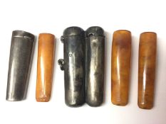 Victorian silver double cheroot holder and one single silver cheroot holder, both containing amber c