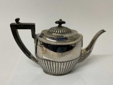George V silver teapot with fluted decoration and ebonised handle and finial, (Sheffield 1910), make