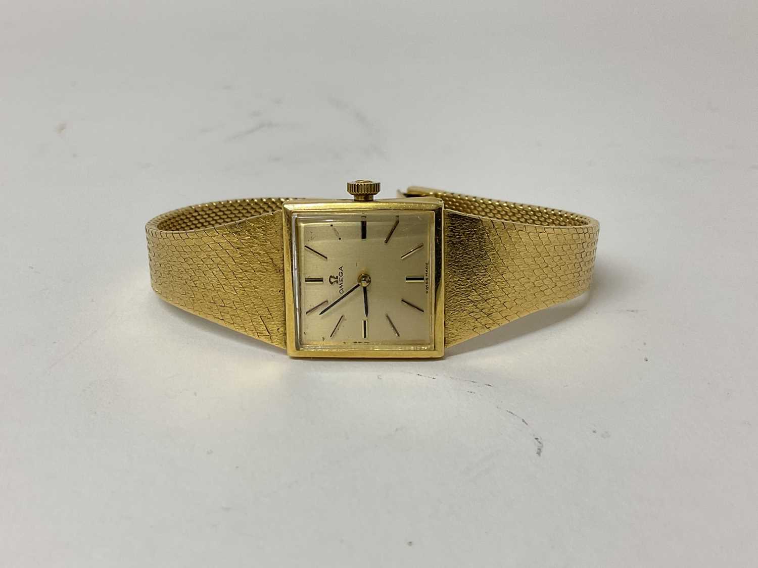Ladies Omega 18ct gold wristwatch on integral 18ct gold milanese strap.