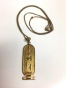 Egyptian gold pendant on gilt metal chain, 45.5cm long