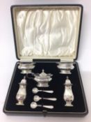 Five piece silver condiment set in fitted case
