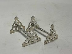 Pair of silver knife rests with pierced trefoil ends