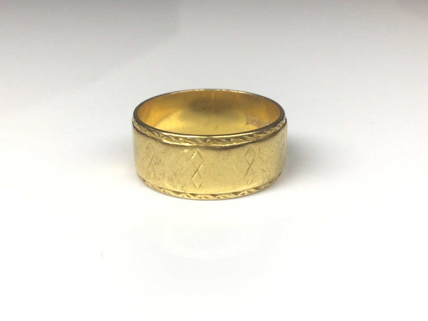 22ct gold wide band wedding ring with engraved geometric decoration