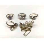 Three 9ct gold gem set dress rings, 9ct gold three pearl cross over ring and 9ct gold cultured pearl