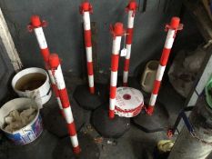 Six red and white weighted base posts and plastic chain