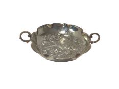 Silver twin-handled bowl, probably American, of foliate form with flower decoration in relief, marke