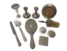 Group of silver, mostly dressing table items, including a pair of weighted candlesticks, a weighted
