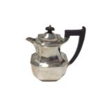 A silver hot water jug, of octagonal form with ebonised handle and knop, Sheffield 1955, 19cm high,