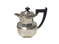 A silver hot water jug, of octagonal form with ebonised handle and knop, Sheffield 1955, 19cm high,