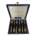 Cased set of six silver gilt teaspoons decorated with black and white enamelling, Birmingham 1975 (T