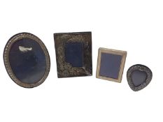 Four silver photograph frames, various sizes