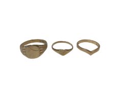 Three 9ct gold rings to include a signet ring, heart shaped ring and a wishbone ring