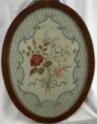 Victorian silkwork oval embroidered panel, a bunch of flowers in a posy with ribbon all within a roc
