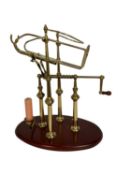 Good quality French brass and mahogany decanting cradle