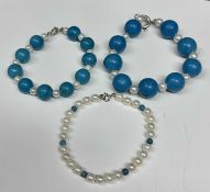 Three contemporary pearl and turquoise bead bracelets with silver clasps