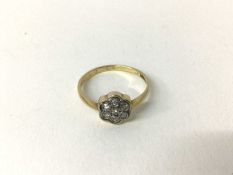 Edwardian diamond cluster ring with a daisy shape flower head cluster of single cut diamonds in plat