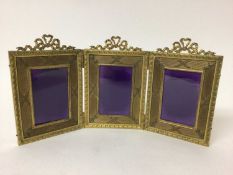 Good quality Edwardian gilt metal folding triptych photograph frame with triple ribbon crestings and